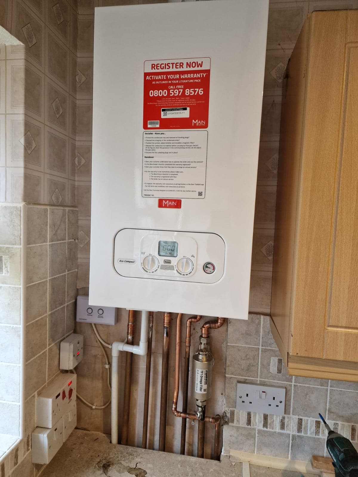 Main Eco Compact boiler installed on kitchen wall with Fernox TF1 Omega magnetic filter and copper pipework