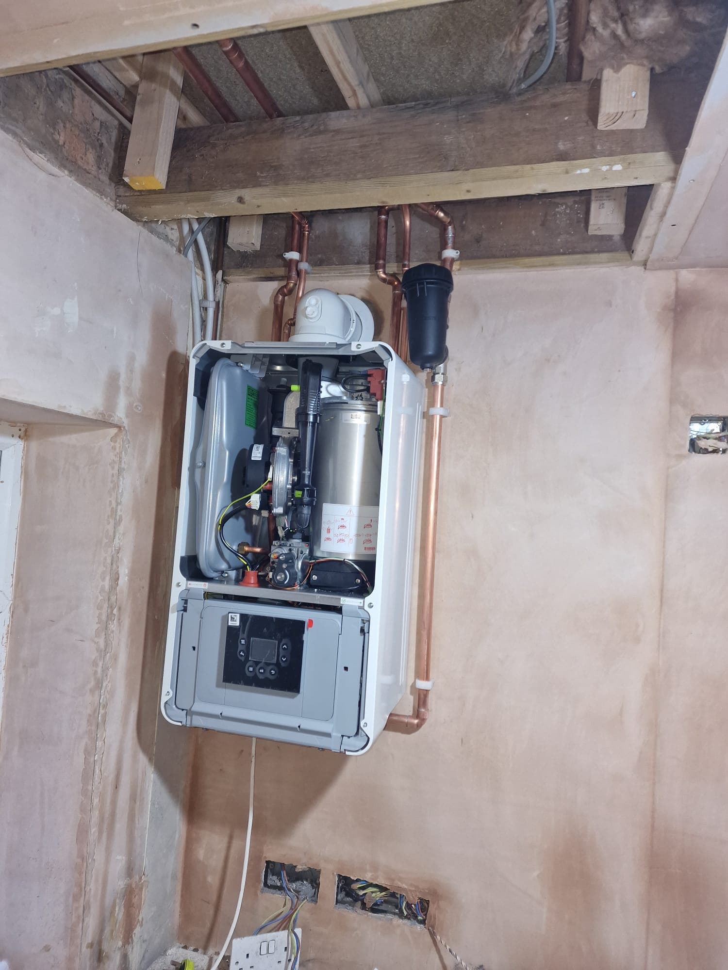 Worcester Bosch boiler mid-installation with casing open showing internal components