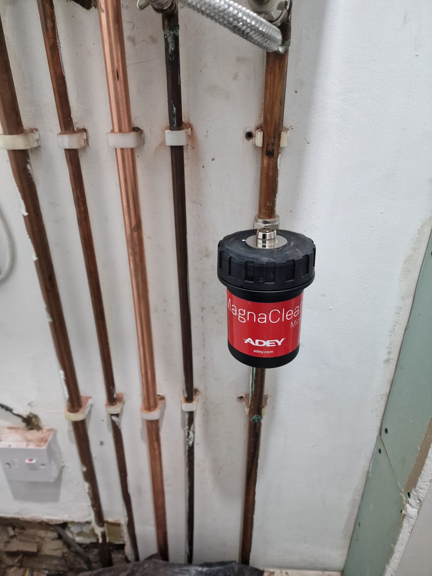 Adey MagnaClean Micro magnetic filter fitted to central heating pipework